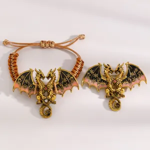 Detail view of vintage enamel double-headed dragon handmade bracelet and matching brooch set