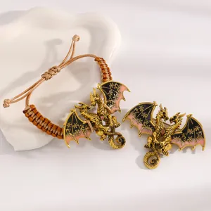 Detailed macro view of high-quality vintage golden dragon enamel bracelet and brooch jewelry set.