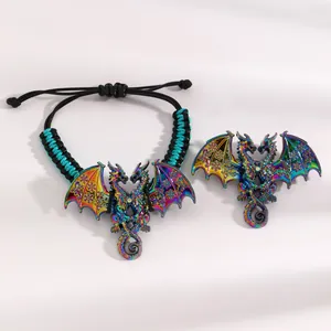 Macro detail of iridescent enamel dragon bracelet and brooch with intricate carvings.
