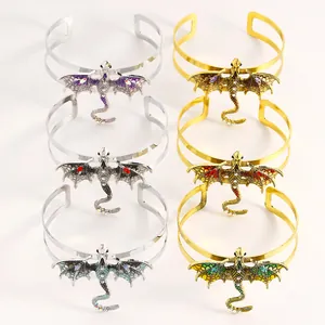 Detailed close-up showing intricate dragon enamel cuffs in gold and silver with crystals