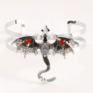 Macro detail showing the dragon wings with black enamel and red rhinestone accents