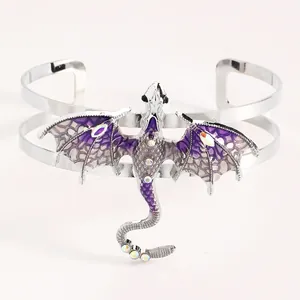 Detailed close-up of vintage purple enamel flying dragon cuff bracelet with rhinestones