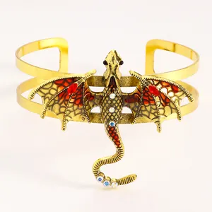 Detailed view of a vintage golden enamel dragon cuff bracelet with sparkling rhinestones