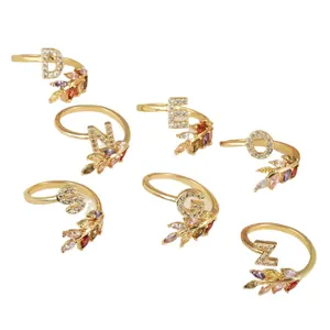 Set of 18k gold plated initial rings with colorful marquise-cut cubic zirconia stones.