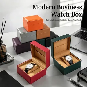 Colorful leather watch storage boxes with soft cushions on a modern desk setup