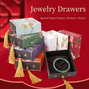 Close-up of Chinese style jewelry drawer boxes with floral patterns and tassels