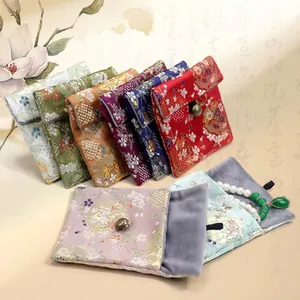 Detailed view showing traditional oriental brocade jewelry pouches in multiple colors