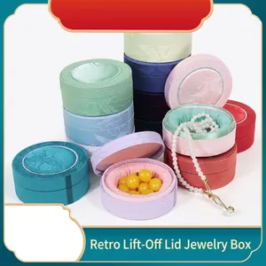 Collection of colorful vintage round jewelry boxes with lids for necklaces and rings