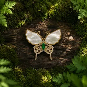 Detailed view of a butterfly brooch with mother-of-pearl wings and a green gemstone