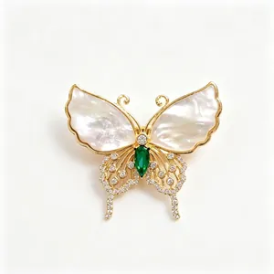 Elegant butterfly brooch with natural shell wings and emerald green stone luxury accessory