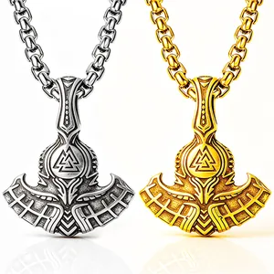 Detailed view of silver and gold Viking Mjolnir axe pendants with Valknut engraving
