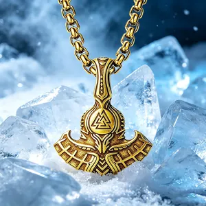 Detailed close-up of a gold Viking Thor's axe pendant with Valknut runes on ice.
