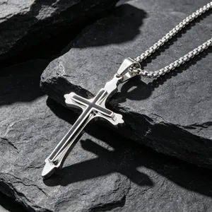 Minimalist titanium steel cross necklace pendant for men on a dark stone background