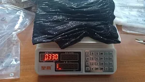 Detail view showing weight measurement of black sequined wide-leg pants for size S