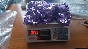 Detailed weight verification showing 0.255kg for a purple sequined bodycon party dress in size M