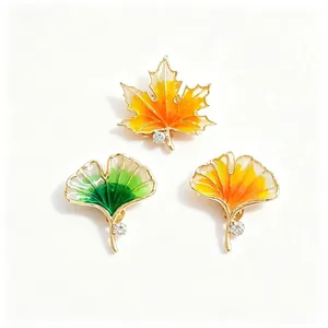 Vintage enamel maple and ginkgo leaf brooches with sparkling rhinestone accents.