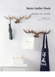 Creative resin antler wall hooks showing functional usage for hanging umbrella and apron