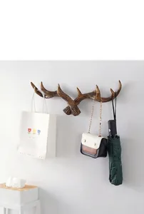 Detail view of vintage antler wall hook used for hanging bags and accessories