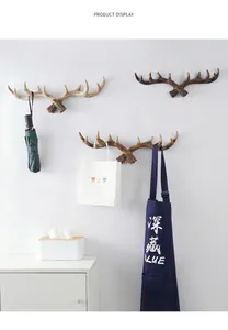Detailed view of three American retro antler hooks used for hanging various items.