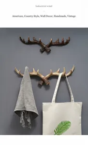 American vintage resin antler wall hooks mounted on wall showing usage with bag