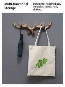 Detail view of retro antler wall hook holding an umbrella and a tote bag