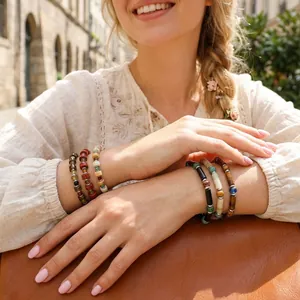 Close-up of handmade beaded bracelets featuring semi-precious stones on a woman's wrist