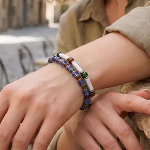 Detailed close-up view of a handcrafted Czech glass bead bracelet worn on a woman's wrist.