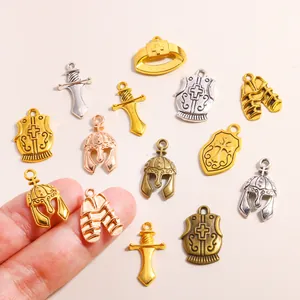 Close-up of vintage alloy charms featuring helmets, shields, and swords for DIY jewelry.