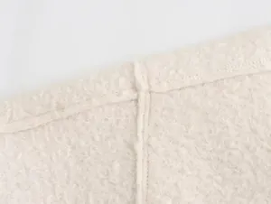 Close-up of fine stitching and soft textured bead fleece fabric for women's jacket