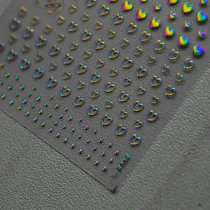 Holographic heart nail art stickers with iridescent finish on transparent backing sheet