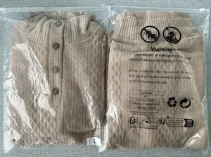 Detailed view of khaki men's cable knit shirt inside protective zipper packaging bag