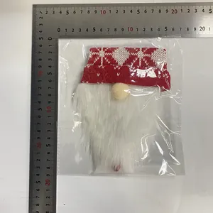 Knitted Christmas gnome wine bottle cover with measurement ruler showing size details