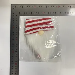 Christmas gnome wine bottle cover in plastic packaging with ruler for size reference