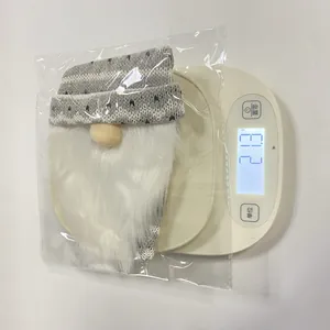 Detailed close-up showing the precise weight of a grey knitted Christmas gnome wine bottle cover