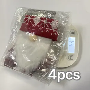 Detailed view of 4pcs Christmas gnome knitted wine bottle covers on a digital scale