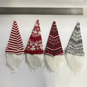 Set of four Christmas gnome wine bottle covers with knitted hats and faux fur beards.