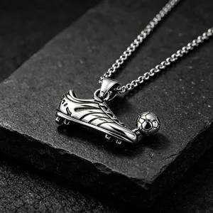 Detailed view of stainless steel soccer cleat and ball pendant necklace for fans