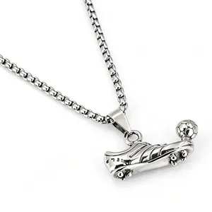 Detailed view of a silver stainless steel soccer shoe and ball pendant necklace for men