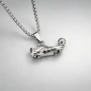 Detailed view of a stainless steel soccer shoe and ball pendant necklace for sports fans