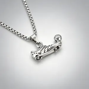 Detailed view of a stainless steel soccer cleat necklace with a small football pendant