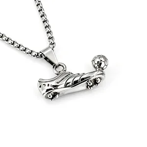 Macro detail shot of a polished stainless steel football shoe and ball pendant necklace
