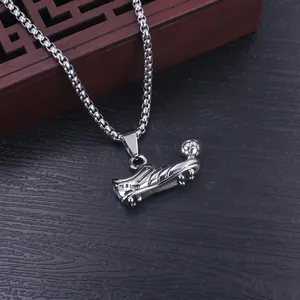 Close-up of stainless steel football shoe and ball pendant necklace with hip-hop box chain.