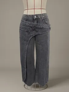Detailed view of the unique asymmetric wrap waist and pockets on charcoal grey washed jeans