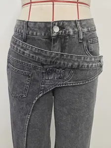 Detailed macro view of trendy asymmetric layered waistband on grey washed denim jeans