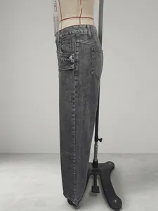 Detailed side view of trendy washed grey high-waisted denim jeans for fashion-forward women