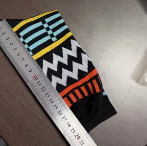 Detailansicht der Längenmessung von modischen Jacquard-Socken mit einem langen Lineal.