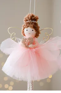 Close-up of a Christmas angel girl ornament with pink tulle dress and gold wings
