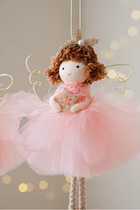 Close-up of pink gauze tutu and golden star on angel girl Christmas ornament