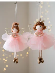 Close-up detail of two cute Christmas angel girl hanging ornaments with pink tulle skirts