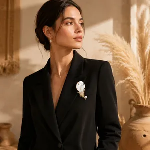 Elegant luxury white mother of pearl feather brooch pinned on a stylish black blazer for women